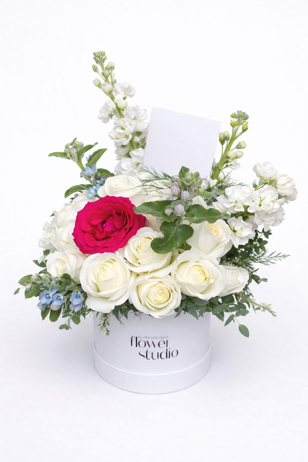 White rose floral arrangement in a white hat box 