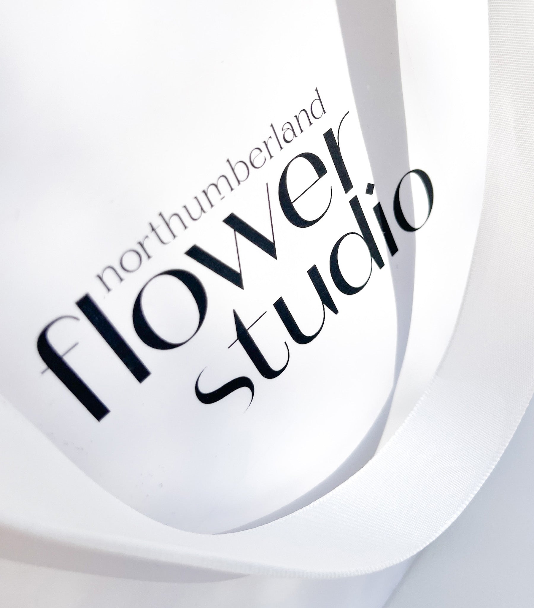 Logo of Northumberland Flower Studio on a white gift bag