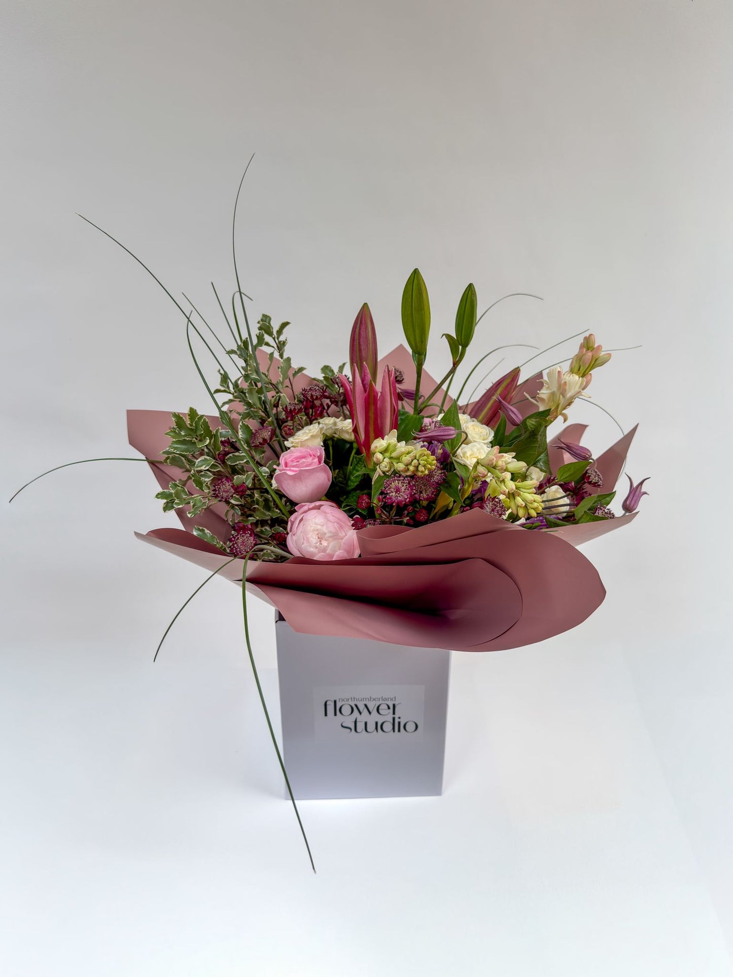 Bouquet of Mother’s Day flowers in a box with 'Northumberland Flower Studio' branding on a white background